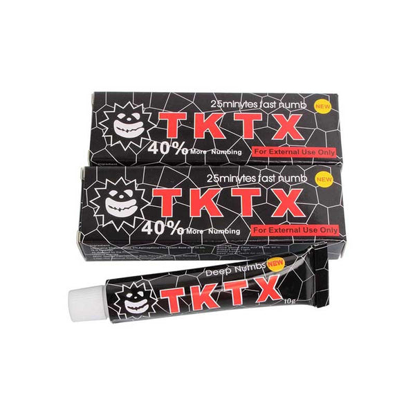 two tubes of tktx toothpaste on a white background