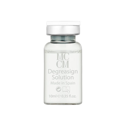 a bottle of mc degreasion solution on a white background