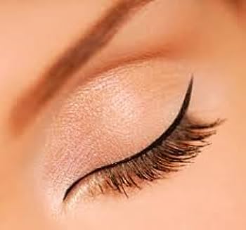 a close up of a woman's eye with long lashes